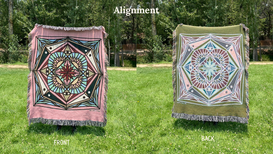 Front and back of a colorful pinks and blacks mandala patterned woven blanket with the back more a greens and blues
