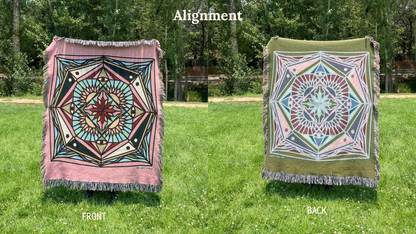 Front and back of a colorful pinks and blacks mandala patterned woven blanket with the back more a greens and blues