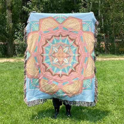 A colorful mandala woven blanket with fringe