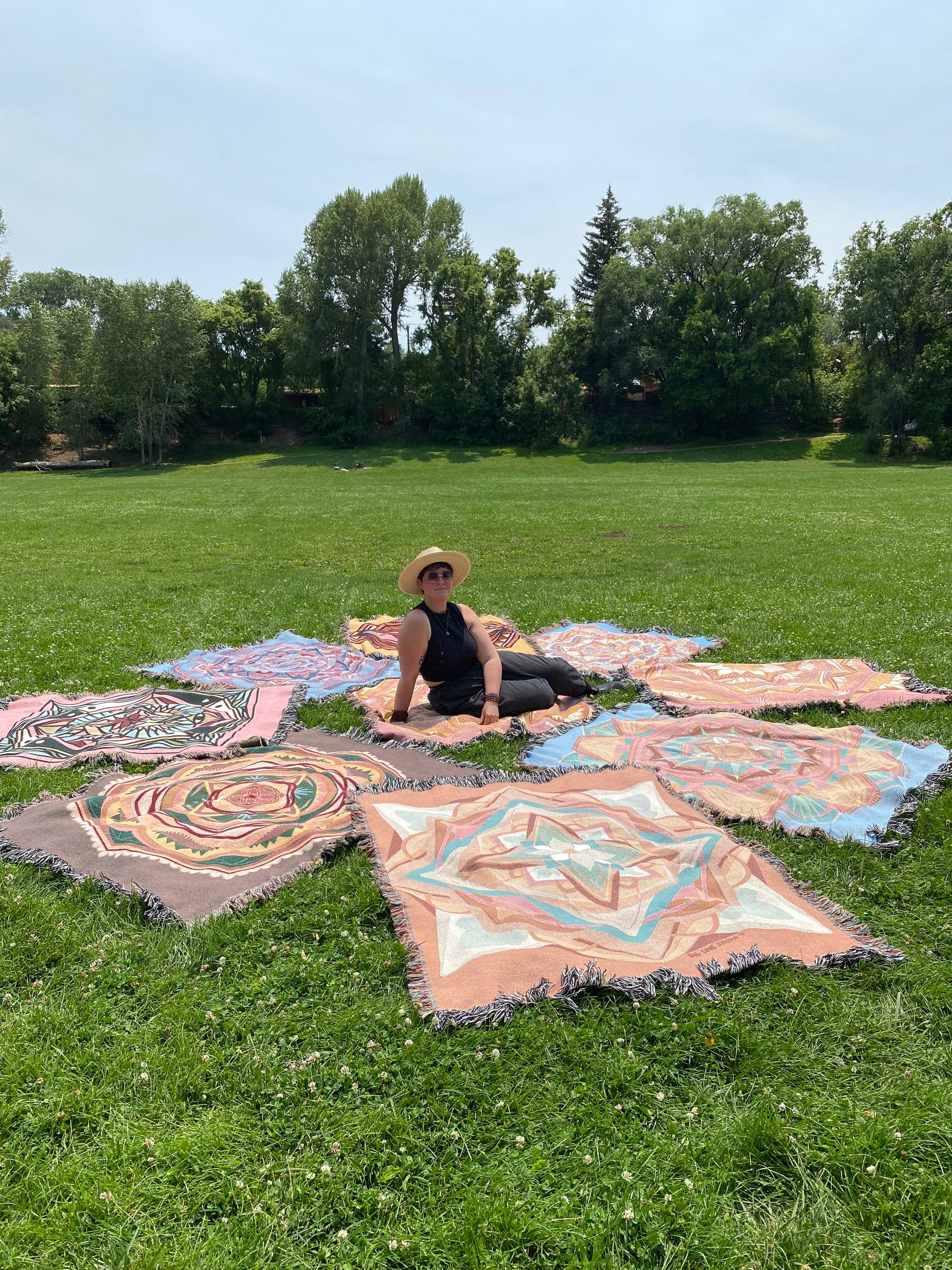 Mackenzie sits among many colorful ritual blankets