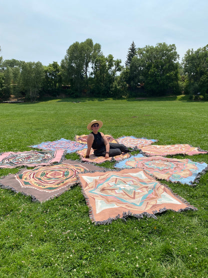 Mackenzie sits among many colorful ritual blankets