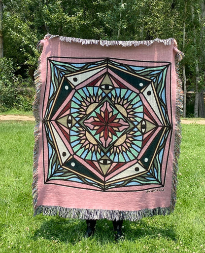 A colorful mandala blanket inspired by stained glass, with fringe