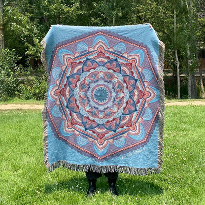 A blue and purple mandala blanket with fringe