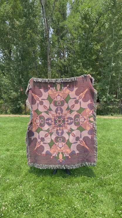 Mackenzie wraps a brightly colored kaleidoscope woven blanket with fringe around her