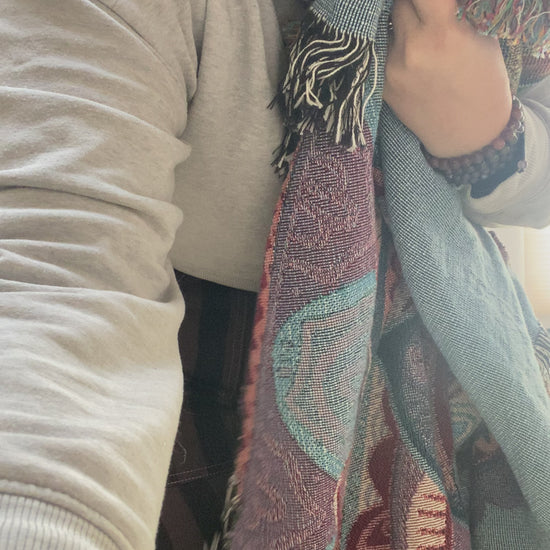 Mackenzie shows off a woven mandala blanket