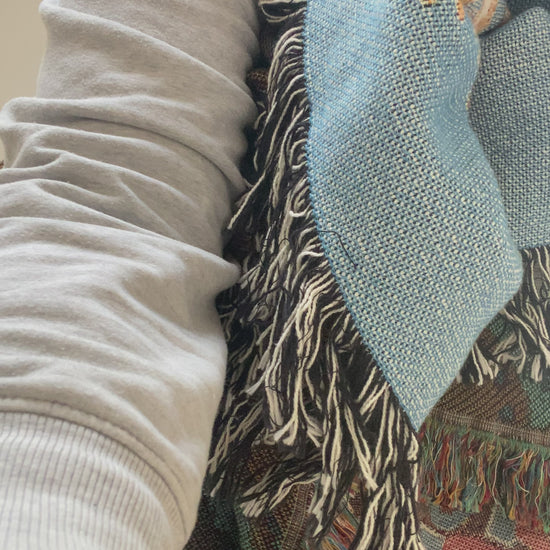 Video of Mackenzie showing a woven blanket