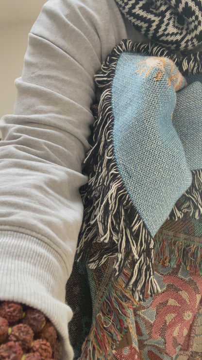 Video of Mackenzie showing a woven blanket